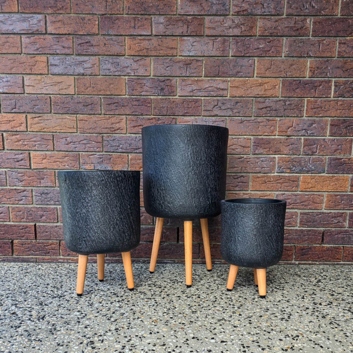 Stone-look fibreclay planter with timber tripod legs- Slate Tripods in Black 