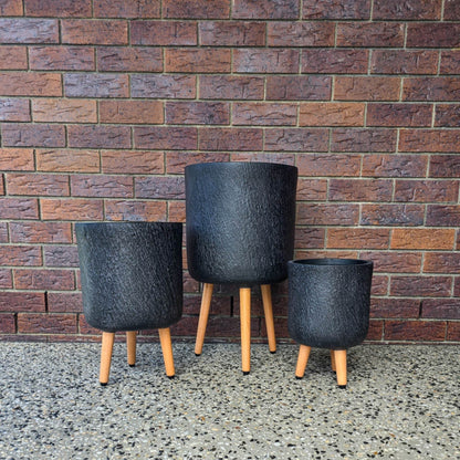 Stone-look fibreclay planter with timber tripod legs- Slate Tripods in Black 